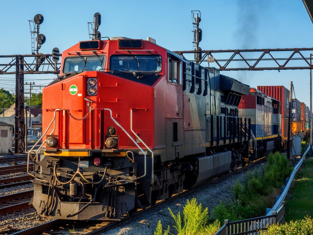 long red train on tracks, getting ready to depart